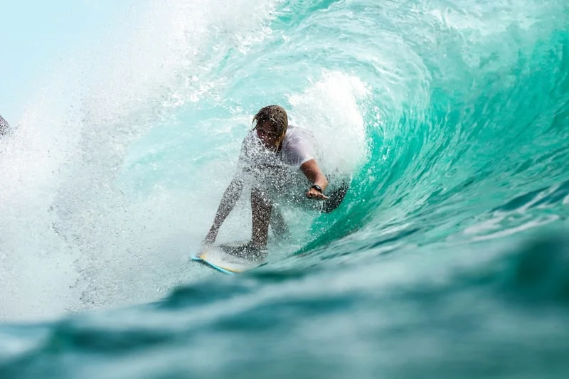 Surfing the waves at Uluwatu, Bali